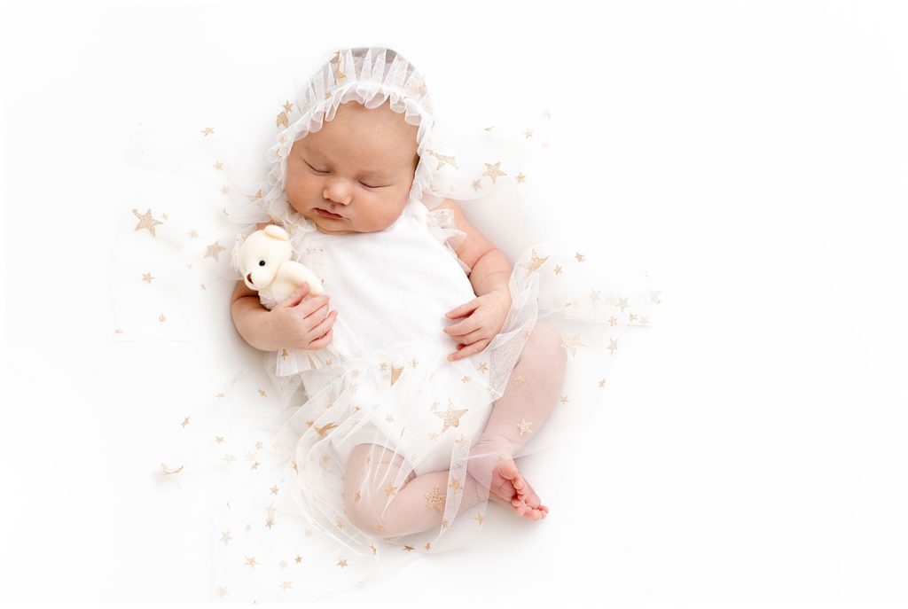studio newborn session with white newborn dress